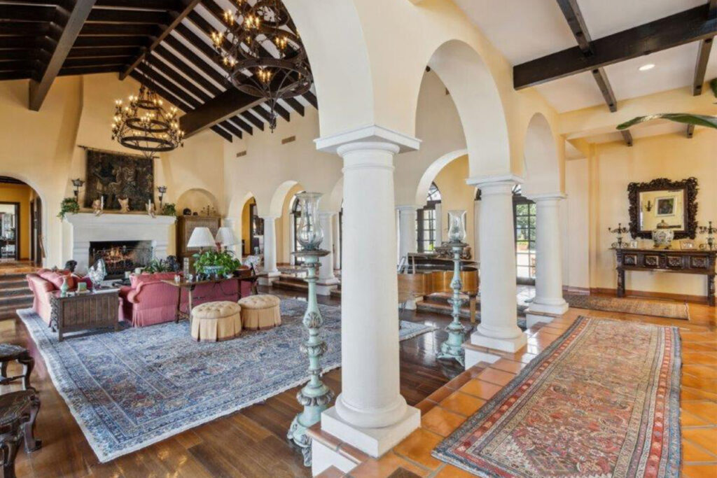 Living room with arches and wood beams.