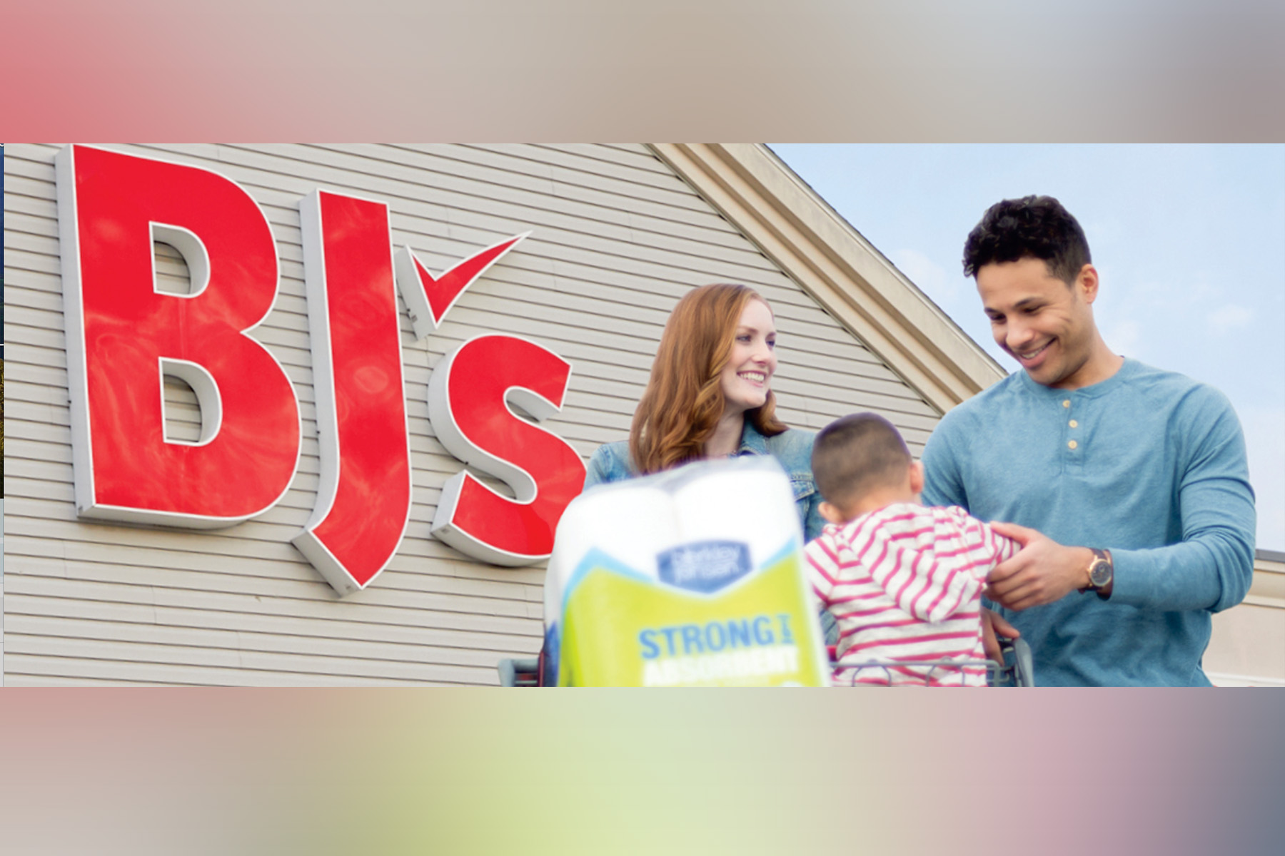 BJ's logo with a couple and their child outside the store.