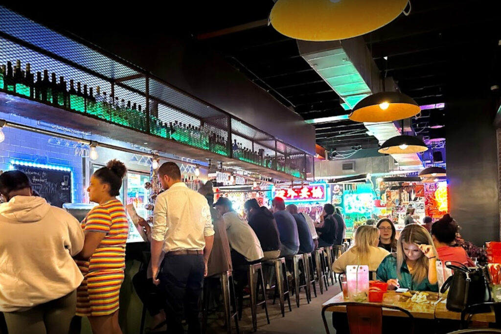 Bustling interior of Hawkers restaurant in Five Points.