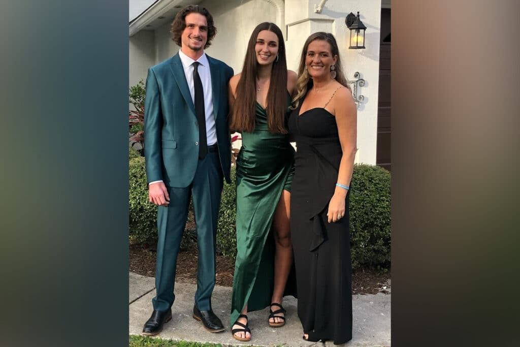 Three people in Ponte Vedra, Florida, wearing formal clothing outside.