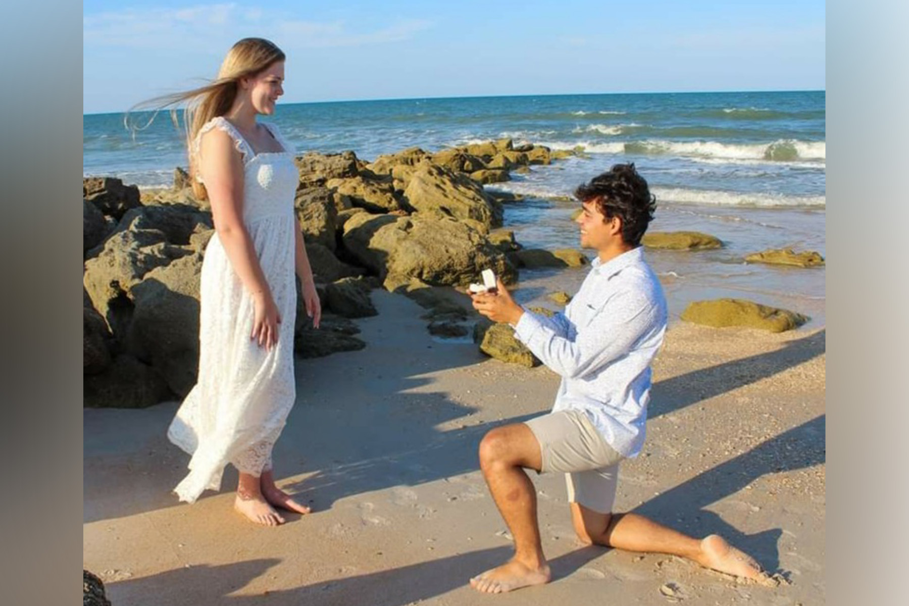 Nicolas Scimone proposes to his fiancee on the beach.