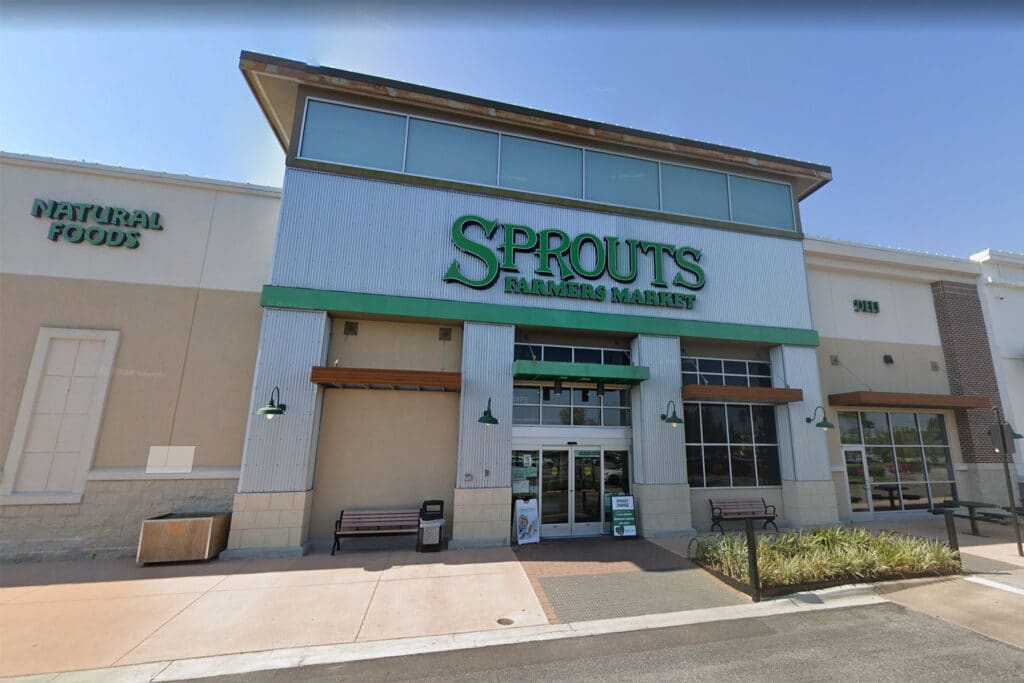 Exterior of a grocery store with a green sign.