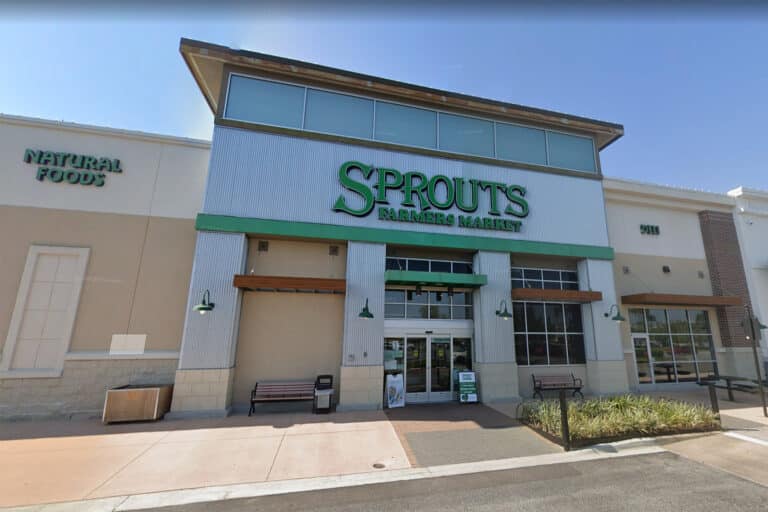 Exterior of a grocery store with a green sign.