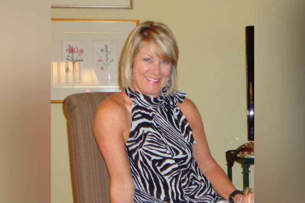 Woman wearing a zebra print shirt.