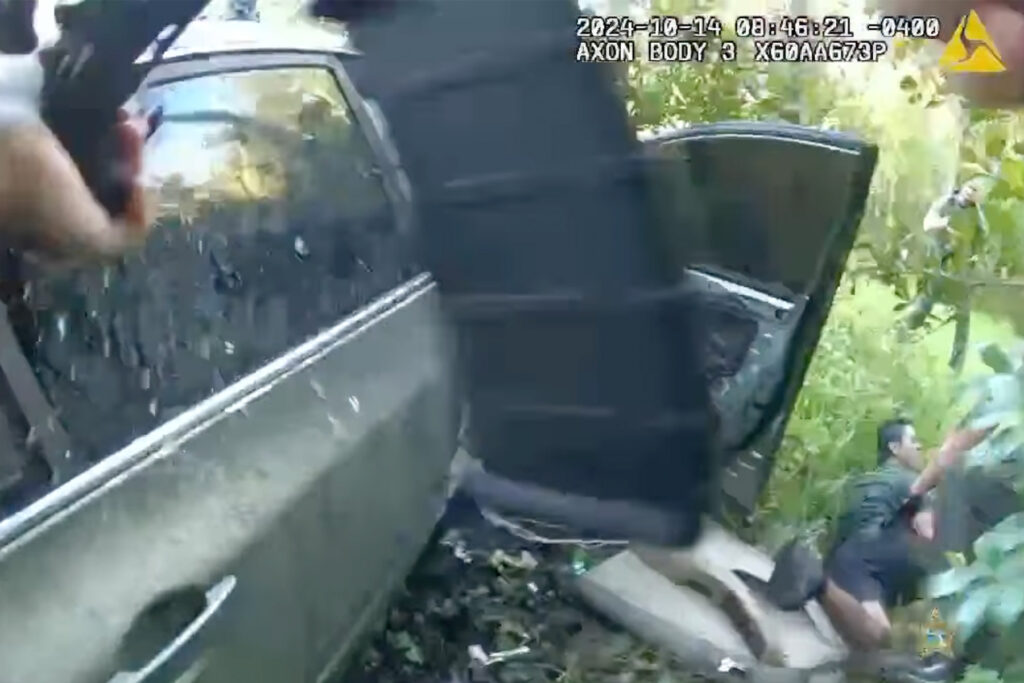 Screenshot of a deputy's body camera showing a teenager on the ground.