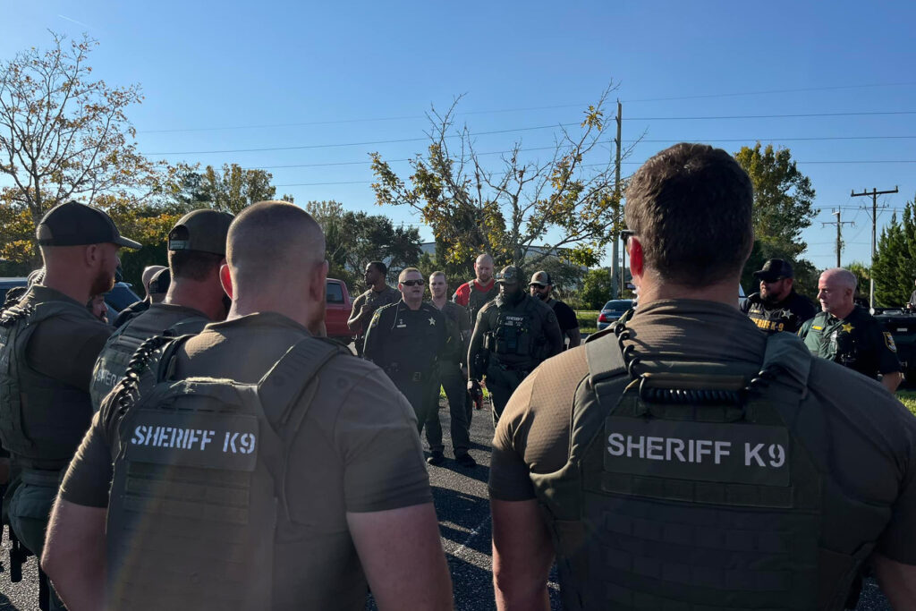 Sheriff Hardwick with his K9 team outdoors.