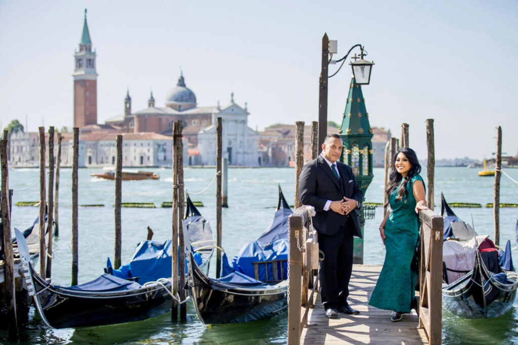 A couple posing on a dock in Venice.