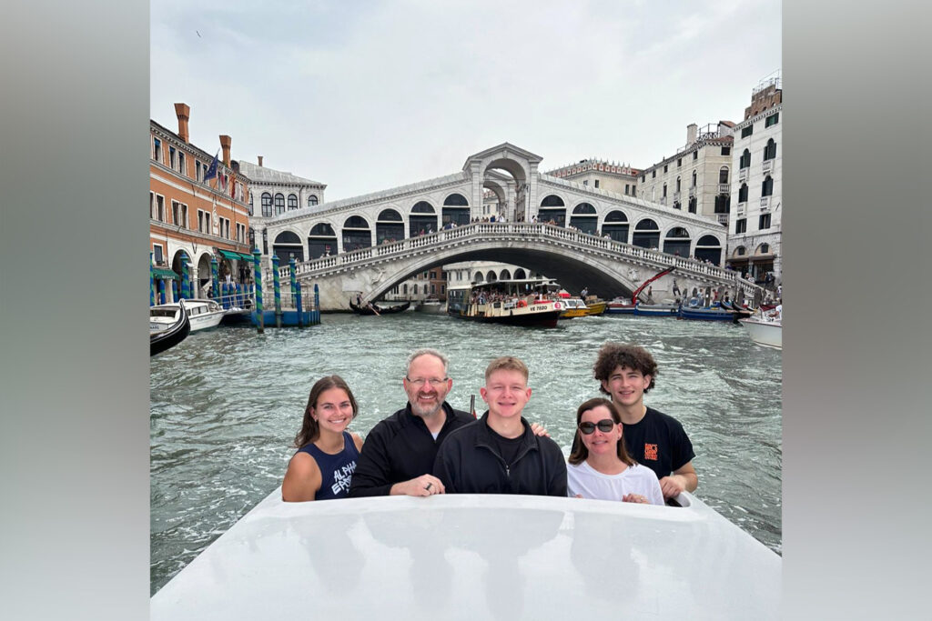 A family in a boat in Italy.