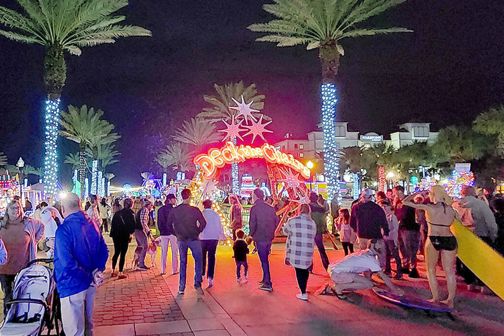 A group outdoors with decorated lifeguard chairs.