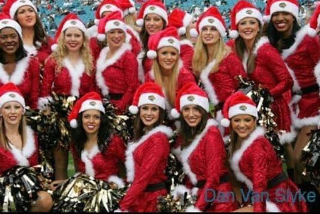 A group of cheerleaders dressed in Santa costumes.