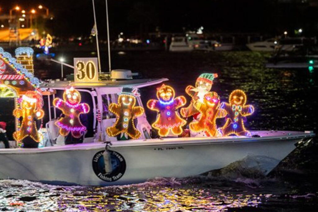 A small boat directed with christmas lights.