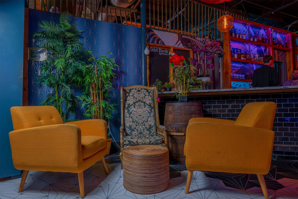 yellow velvet chairs in a dark bar.