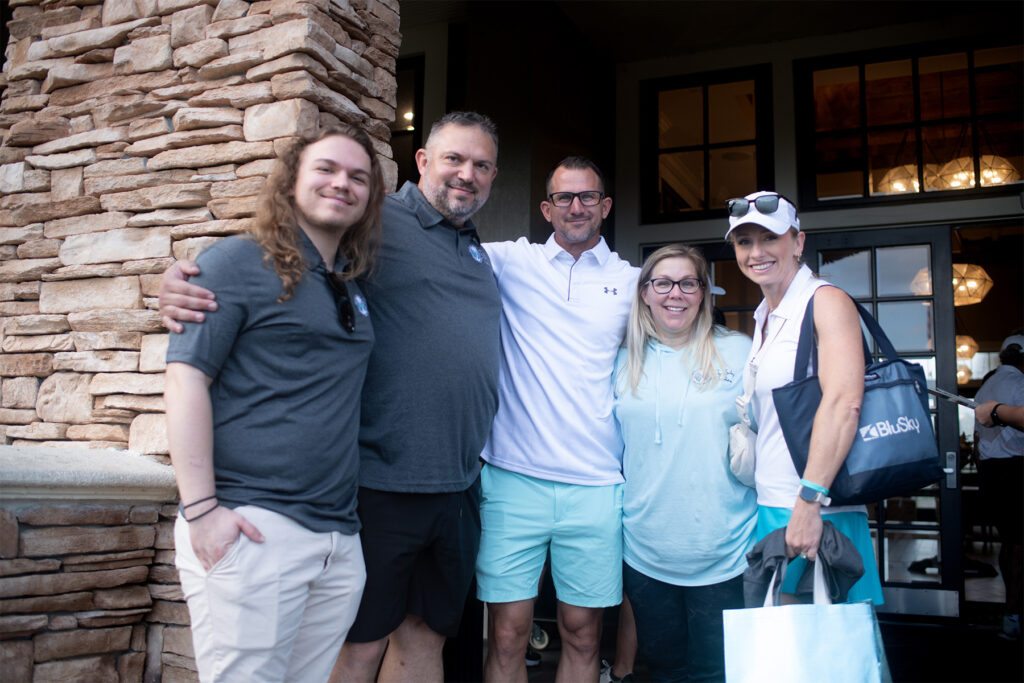 Five people stand for a photo.