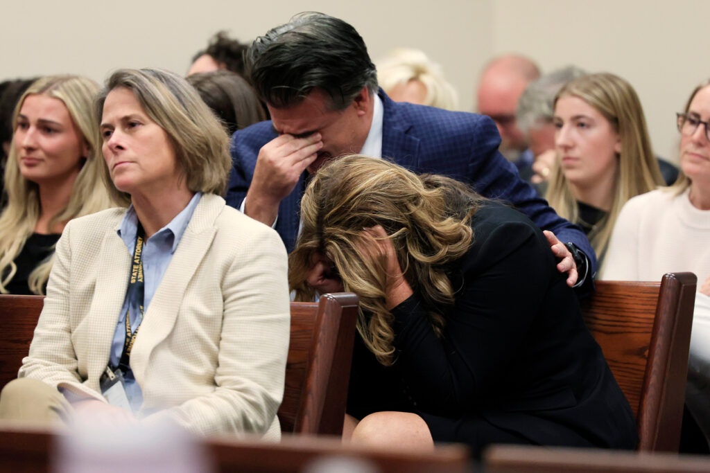 Spencer Pearson's parents bow their heads and sob.