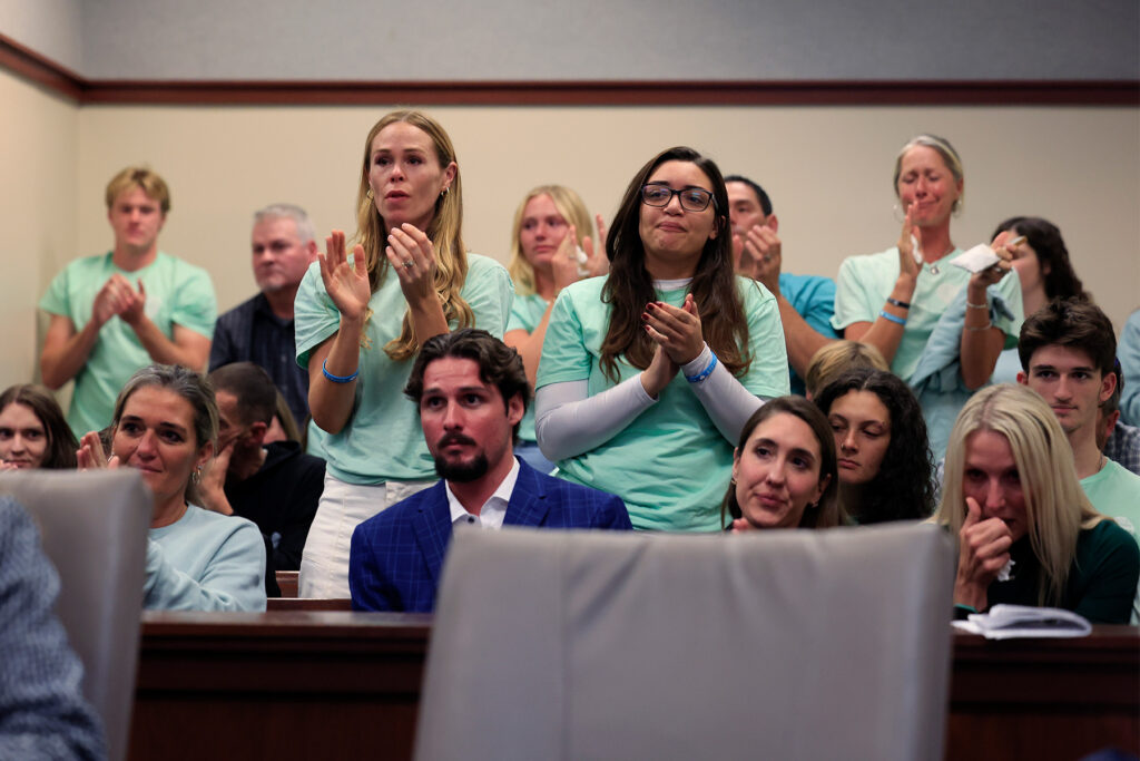 Group of people give standing ovation after Madison Schemitz's victim impact statement.