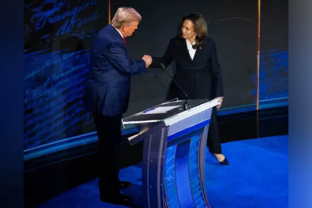 A man and woman shake hands.