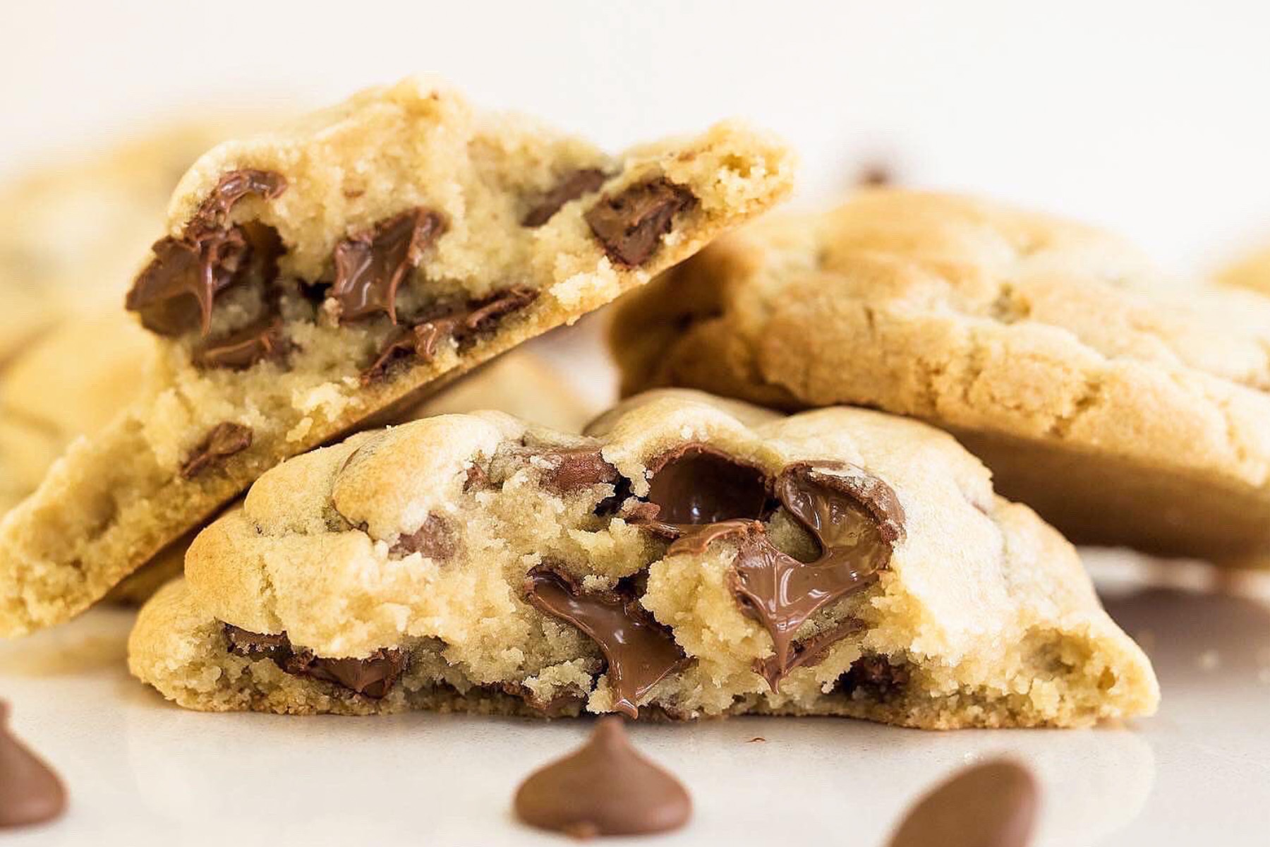 Close up of a chocolate chip cookie that has been broken in half.