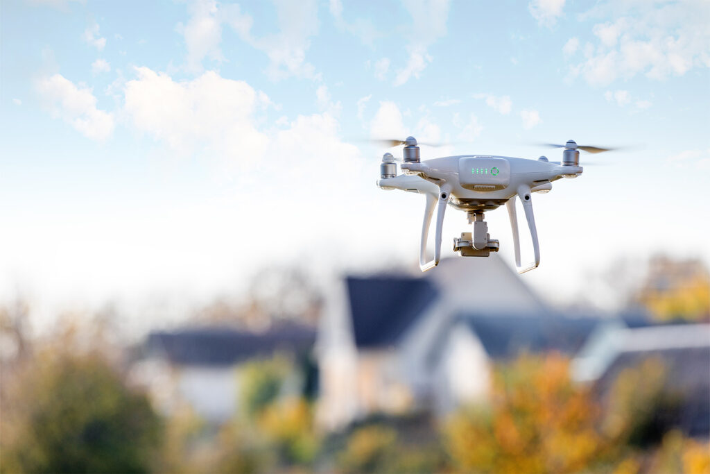 Drone flying near suburban homes.