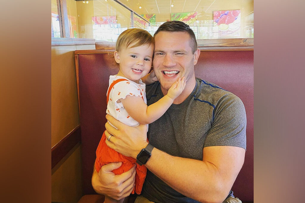 Man holds toddler daughter.