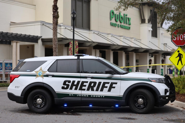 picture of a police car in front of a supermarket