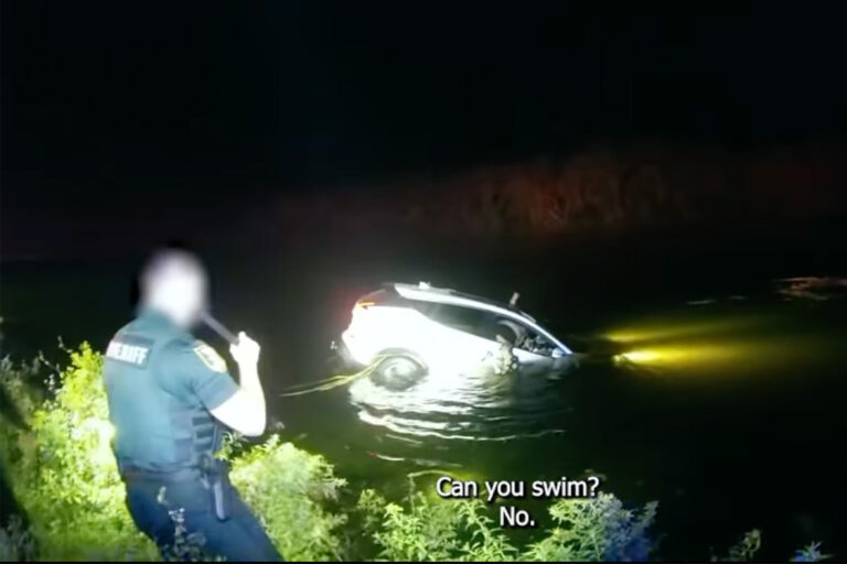 Car sinking in St. Augustine pond at night.