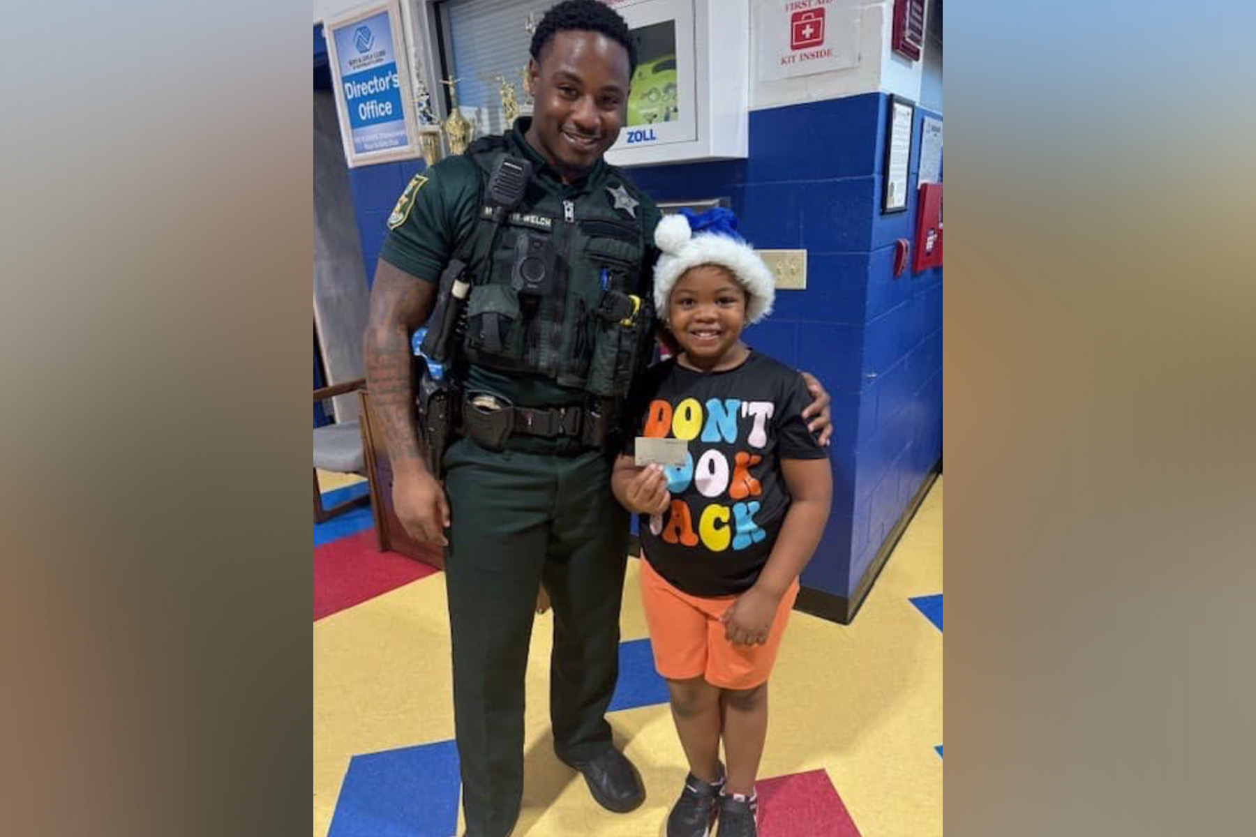 Picture of a police officer and a child.