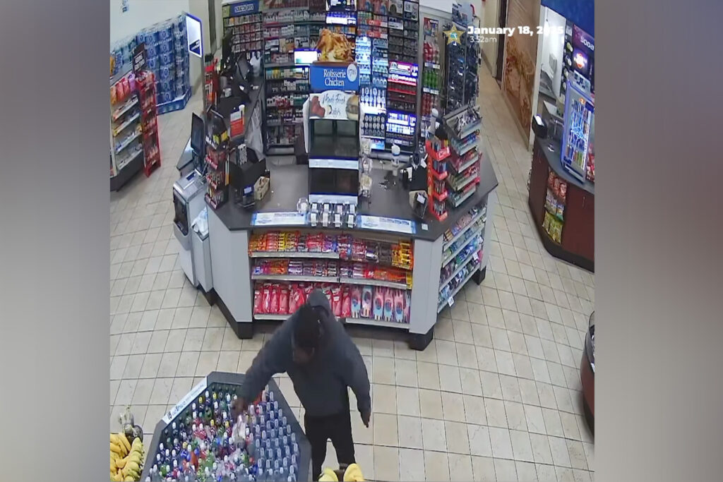 Man in convenience store grabbing bottle.