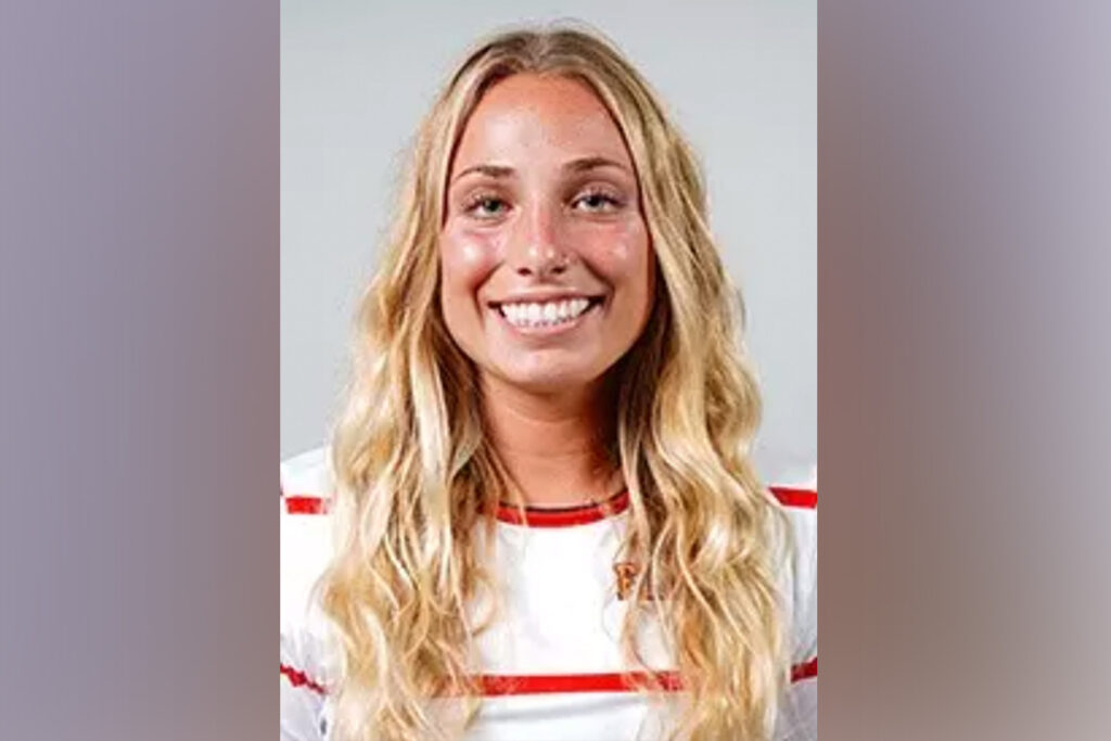 Headshot of blonde woman wearing a red and white shirt.