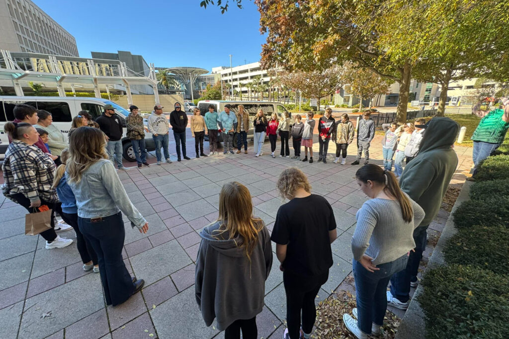 Photo of group prayer outside hospital