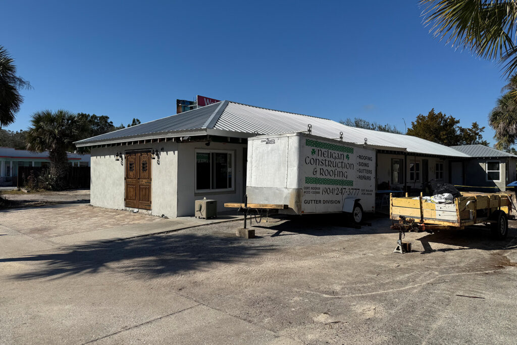 Exterior of a single story, silver roofed building.
