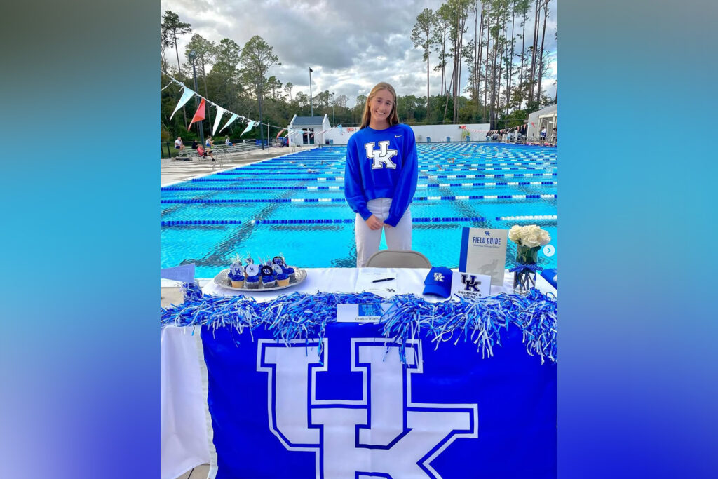 picture of female swimmer in front of a pool