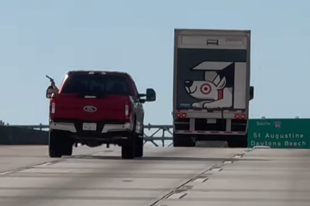 Picture of man firing gun from driver's side window.