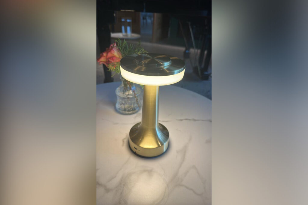 Gold lamp sitting a marble table top.