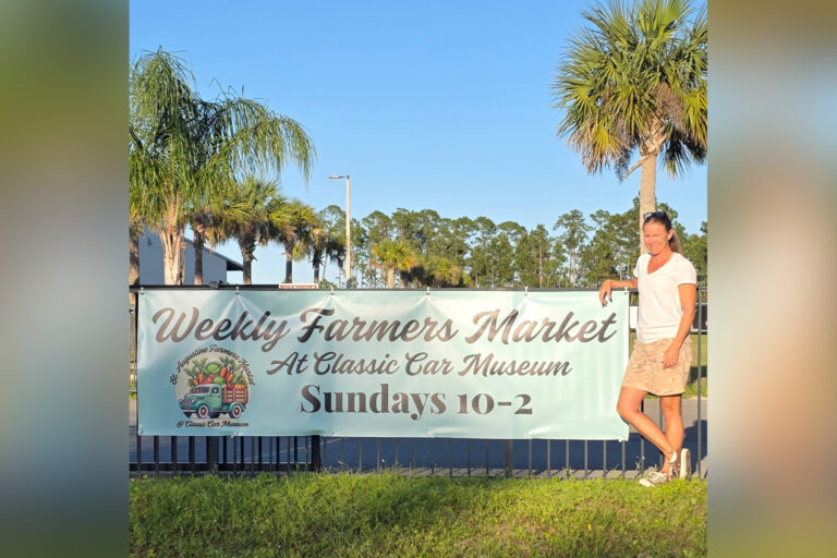 Woman in front of farmer's market.