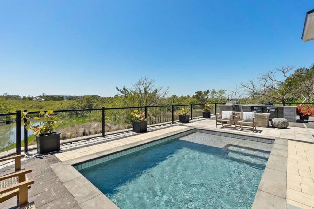 Glistening blue pool overlooking a waterway.
