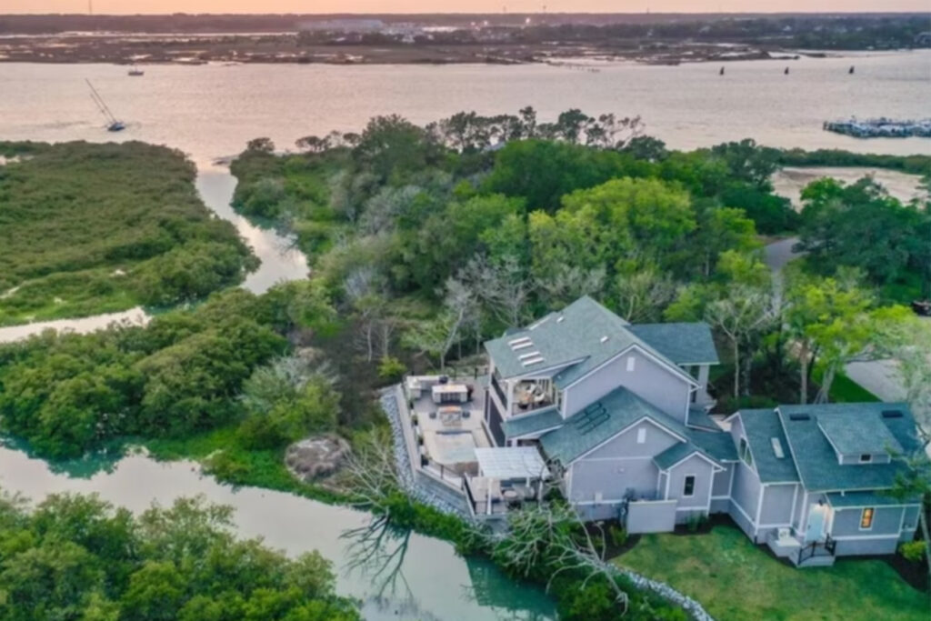 Aerial view of a two-story home near a winding river.