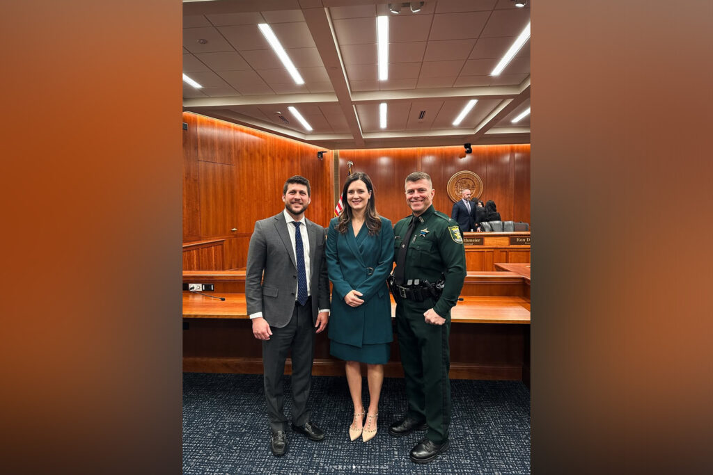 Picture of two police officers and a woman