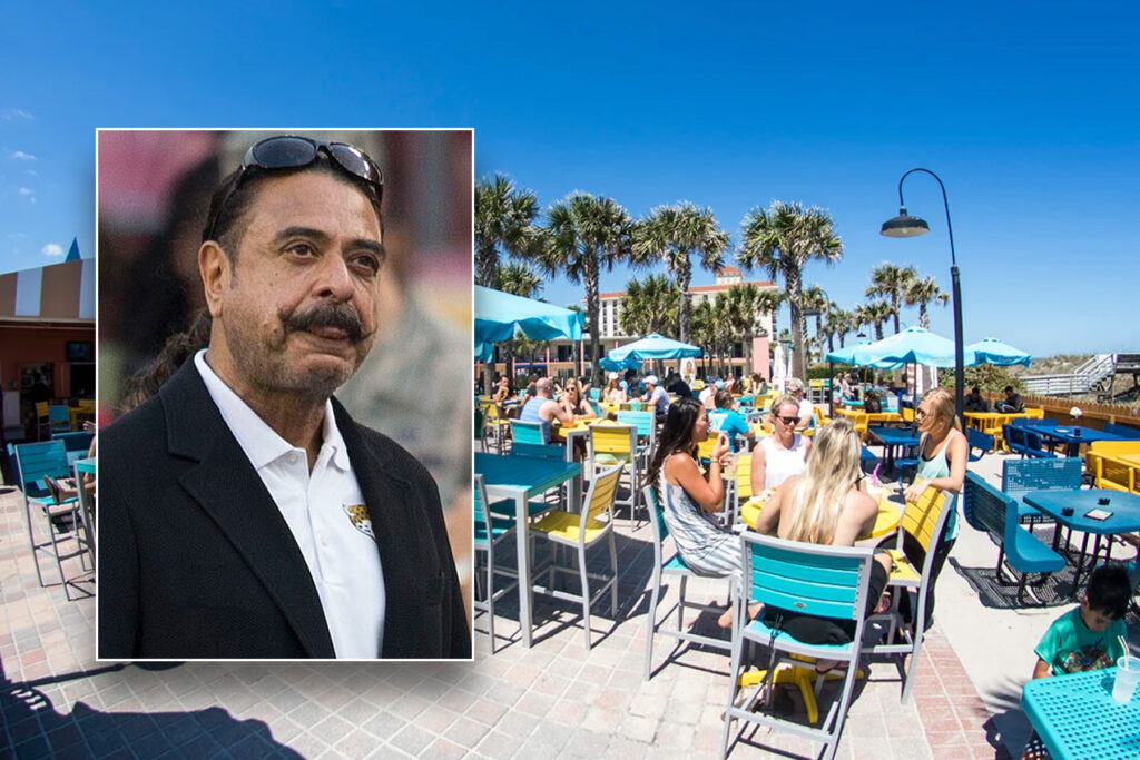 Man with mustache inset over outdoor bar with blue umbrellas.