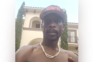 Football player in front of his home.